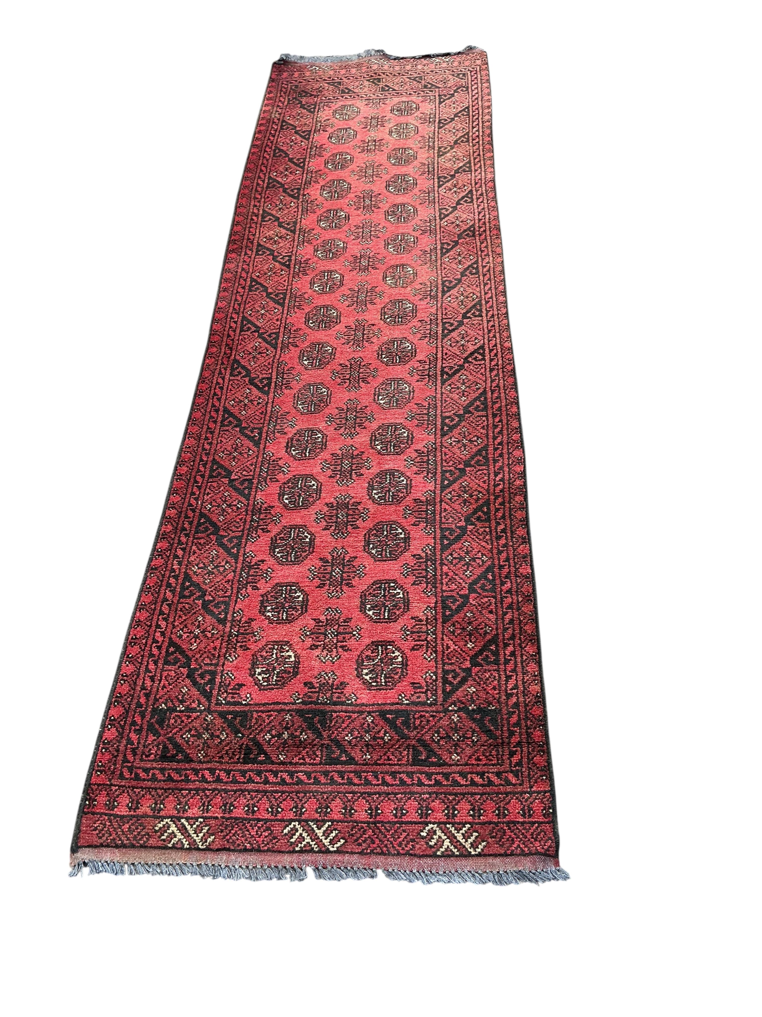 A Bokhara runner, 295 x 81cm